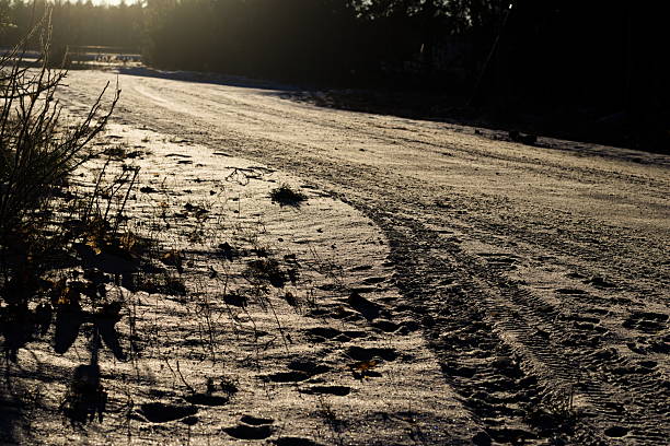 Snow covered pedestrian path in winter city, icy sidewalk texture, cold weather urban landscape