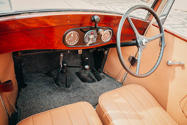 Prague, Czech Republic. August 21st, 2009: Interior view of a vintage car featuring a classic wooden dashboard, analog gauges, manual controls, and a traditional steering wheel. Timeless automotive design showcasing craftsmanship and nostalgic style from an early era of motoring.