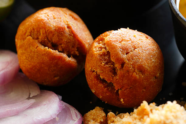 Golden baked baati balls, traditional Rajasthani wheat bread served with Indian meals.