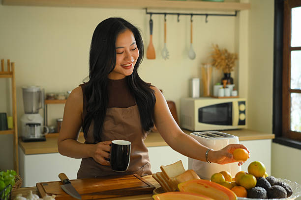 Smiling woman preparing healthy breakfast in a warm kitchen