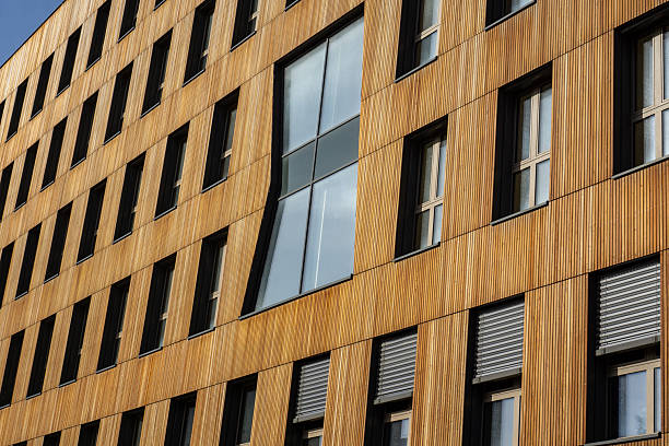 This striking image showcases a residential building featuring unique wooden high-rise architecture, blending modern design with natural materials. The innovative use of wood not only enhances the aesthetic appeal but also promotes sustainability, reflecting a growing trend in eco-friendly construction. Ideal for projects related to architecture, urban development, or sustainable living, this scene highlights the harmony between contemporary design and environmental consciousness. The building's intricate details and textures invite viewers to appreciate the beauty of architectural innovation, making it a perfect choice for themes centered around modern living, design trends, and the future of urban spaces.