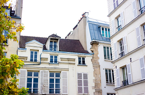 Paris, France: A group of old residential buildings in the Marais with dormer windows, 3rd arrondissement.