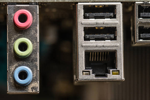 Computer motherboard rear panel with audio jacks and USB ports.
