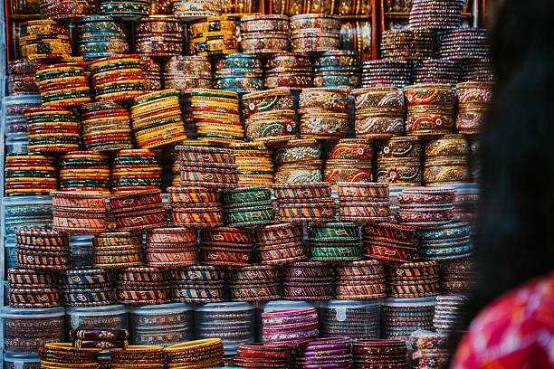 Vibrant, colorful bangles fill a market stall in Pushkar during the fair, showcasing traditional Indian craftsmanship. Bright patterns, textures, and stackable bracelets evoke bustling street commerce and festive culture.
