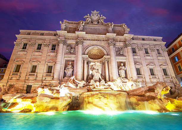 Rome, Italy, January 16 -- The evening lights leave room for artificial light in the splendid scenery of the Trevi Fountain, built in 1732 on the wishes of Pope Clement XII. The Trevi Fountain, one of the symbols of the late Roman Baroque, it's recognized as one of the most beautiful and famous fountains in the world. Image in HD format.