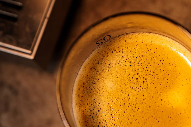 The delicate crema of espresso, and the captivating interplay of light and shadow created by light filtering through the glass.