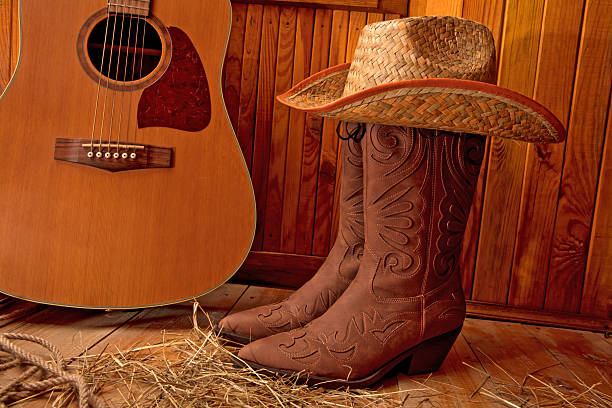 Country music festival live concert with cowboy hat and boots by ranch stables