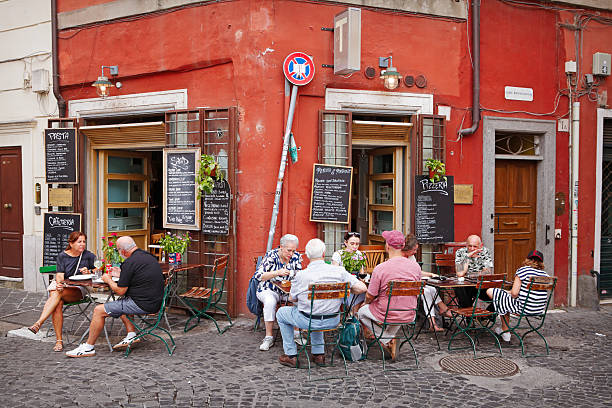 Rome, Italy - Aug 29, 2025: Tourist enjoying food and drinks on the street at local pizzeria in the centre of Rome