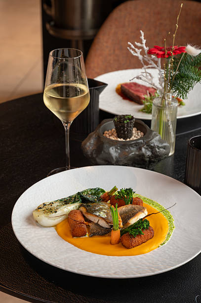 High-end restaurant service showcasing a gourmet fish dish with attention to detail and presentation.