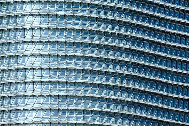 Close-up of a modern glass building facade with curved lines.