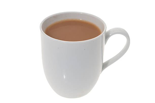 A white mug of hot drink containing tea or coffee - on a white background