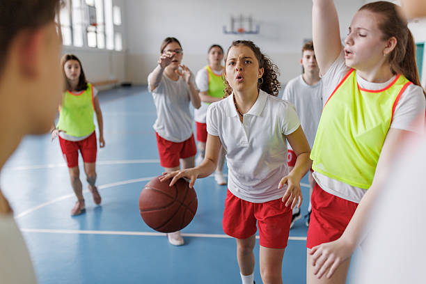 istock Teenagers playing basketball during physical education class. 2259286327