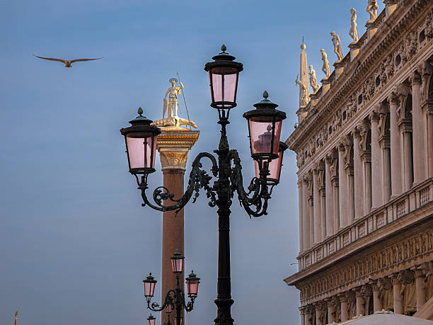 A streetlight with sun flare in the city of Venice