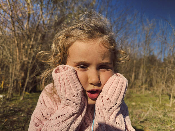 portrait of a smiling little girl in a field
