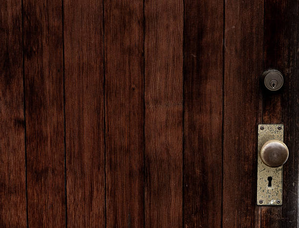 Old wooden door, doorknob of an old house.