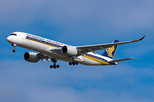 An Airbus A350 aircraft operated by Singapore Airlines flying with blue sky in the background