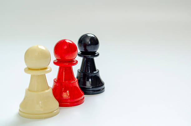 Chess battle setup with a black pawn against white crystal pieces on a mirrored board, creating contrast over a vibrant yellow backdrop