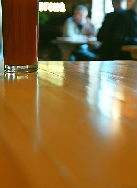 A glass with a drink on a table in a cafe.