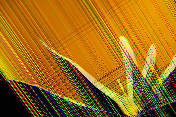 Close-up view of a broken digital screen with an orange background, featuring bright multicoloured lines and intricate cracks representing data corruption and system failure impact