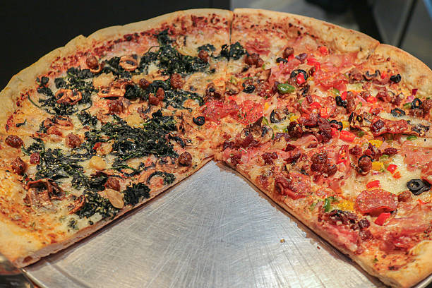 Half vegetarian and half bacon pizza on thin crust, representing shared comfort food and flexible modern eating preferences.