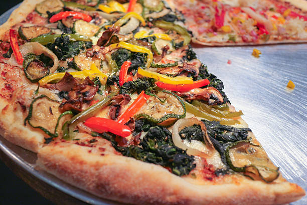 Vegetarian pizza with colorful roasted vegetables on thin Italian crust, highlighting plant based comfort food and healthy eating lifestyle.