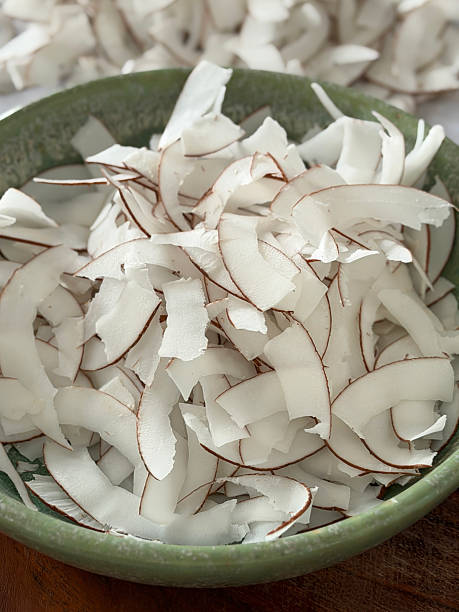Image of coconut shavings and grated dried coconut from fresh coconuts, showcasing tropical exotic ingredients, natural textures
