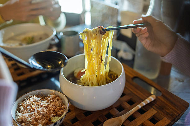 Japanese Ramen Noodles Being Lifted with Chopsticks