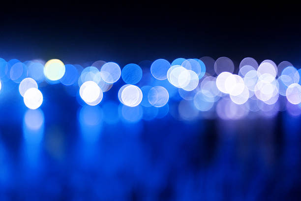Abstract blue bokeh lights background, defocused blue city lights at night