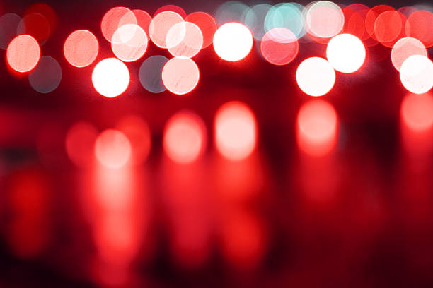 Abstract red bokeh lights background, defocused red city lights at night