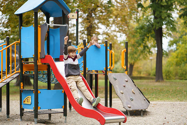 Children playing together on outdoor playground enjoying childhood and leisure activity.