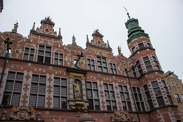 Poland, Gdansk historic centre. Hanseatic League style architecture, Long Market in the Old Town. The Great Armoury in the background. Shallow focus on the stone gargoyle in foreground.