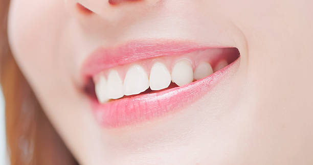 Closeup asian woman with a bright smile and health teeth