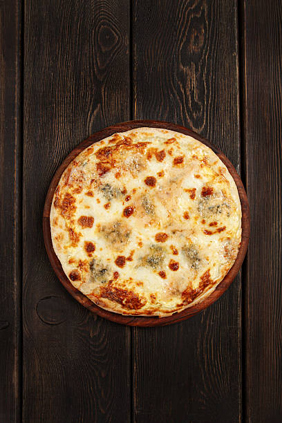 Freshly baked cheese pizza, with a golden crust and bubbling melted cheese, white pizza, on a wooden board, homemade, no people,