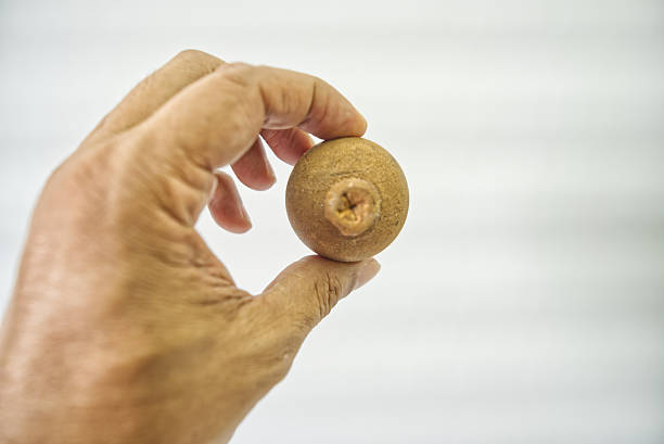Close-up of hand exercising with a therapy ball.