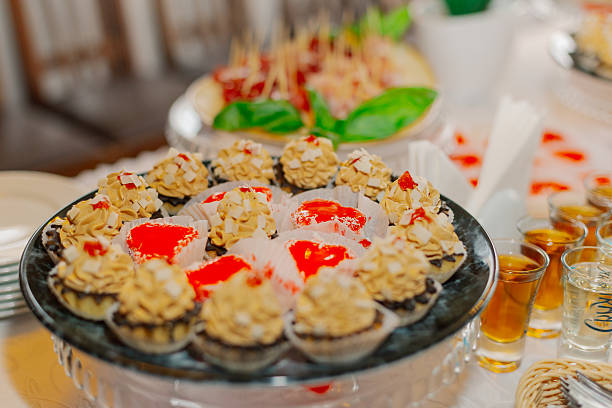 A beautifully decorated table with snacks on it with snacks and cakes for the holiday. The cakes in the foreground are large.