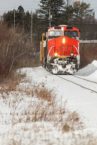 A diesel locomotive switches tracks in a small railyard.