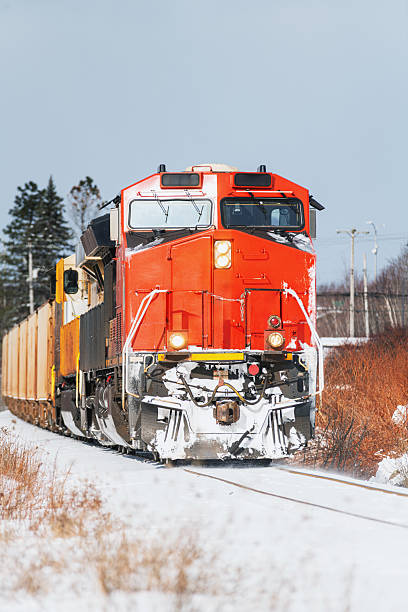 A diesel locomotive switches tracks in a small railyard.
