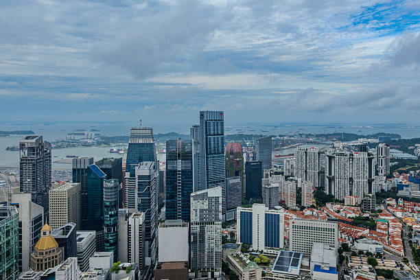 Daytime view of Singapore skyline featuring modern skyscrapers and dense urban architecture. Bright cityscape showcasing Southeast Asia’s financial hub, contemporary buildings, and vibrant metropolitan atmosphere. Concept of business district, economic growth, travel destination, and modern city life.