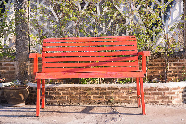a one red wood chair in the garden