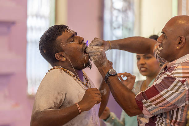 01 February 2026, George Town - Penang Island.Inside the temple, a devotee takes part in a ritual where a vel pierces his face as an act of faith and penance. Although physically demanding, this moment reflects deep devotion and personal commitment, as some participants choose intense practices to honor Lord Murugan during Thaipusam.
