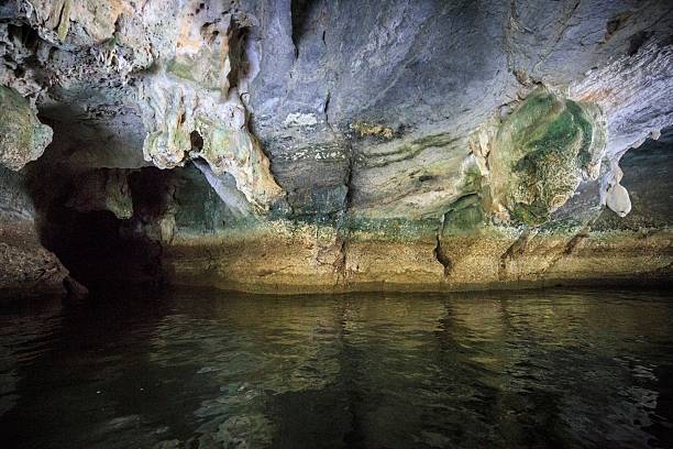 istock Emerald Moss and Ancient Stalactites within a Sea Cave 2259511724