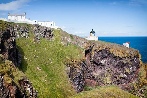 Holidays in Scotland -  Cliff coast with St. Abbs Lighthouse, UK