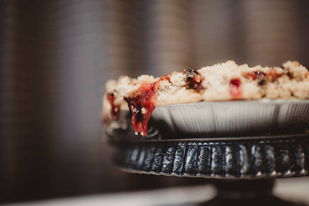 Close up of rhubarb cherry pie with crust and booked edges with copy space