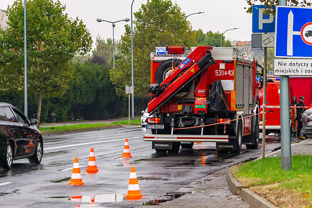 Kalisz, Greater Poland Voivodeship, Poland - October 08, 2025 Rear view of a Scania technical rescue truck parked on wet pavement, secured by cones, used by Polish fire service for accident recovery during drills