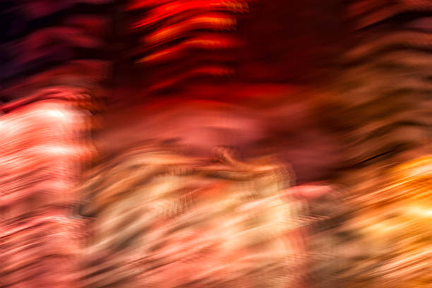 Abstract photographic artwork created with intentional camera movement, featuring fluid motion blur in warm red, orange and golden tones. Expressive fine art background with dynamic texture, energy and painterly atmosphere. Suitable for creative concepts, emotions, music, design and visual storytelling.