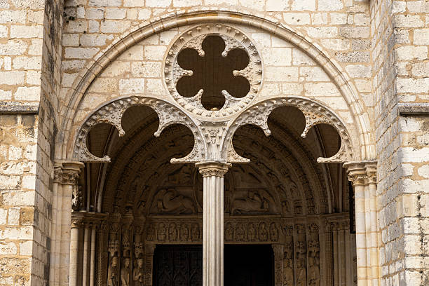 Bourges Cathedral central portal showing carved stone tympanum, column, and rosette tracery