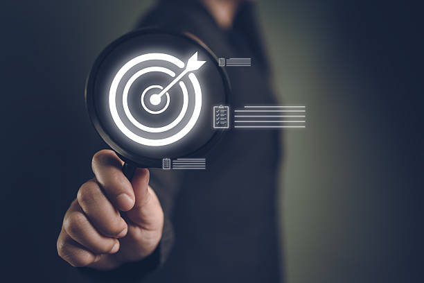 istock Close-up magnifying glass highlighting target icon, symbolizing focus, analysis, and business goal achievement 2259526466