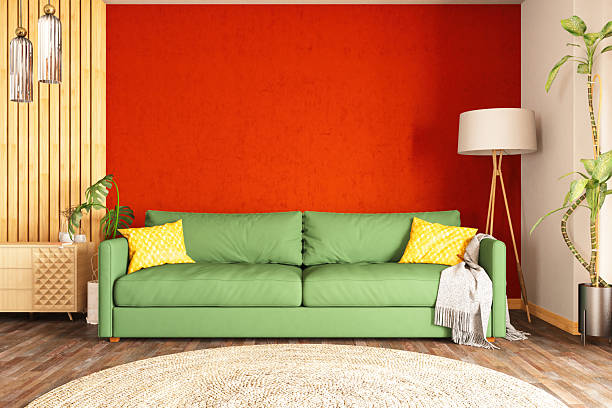 Modern Living Room with Green Sofa and Vibrant Orange Wall. 3D Render