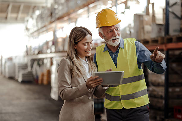 istock Female Store Manager Discussing Logistics with Senior Warehouseman 2259541216
