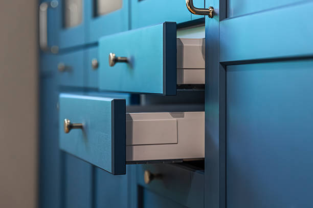 Close up of matte blue fronts with warm metal handles and clean geometry. A premium minimal aesthetic for modern interior design and organizing concepts.